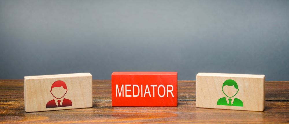 Wooden blocks with the word Mediator and two people