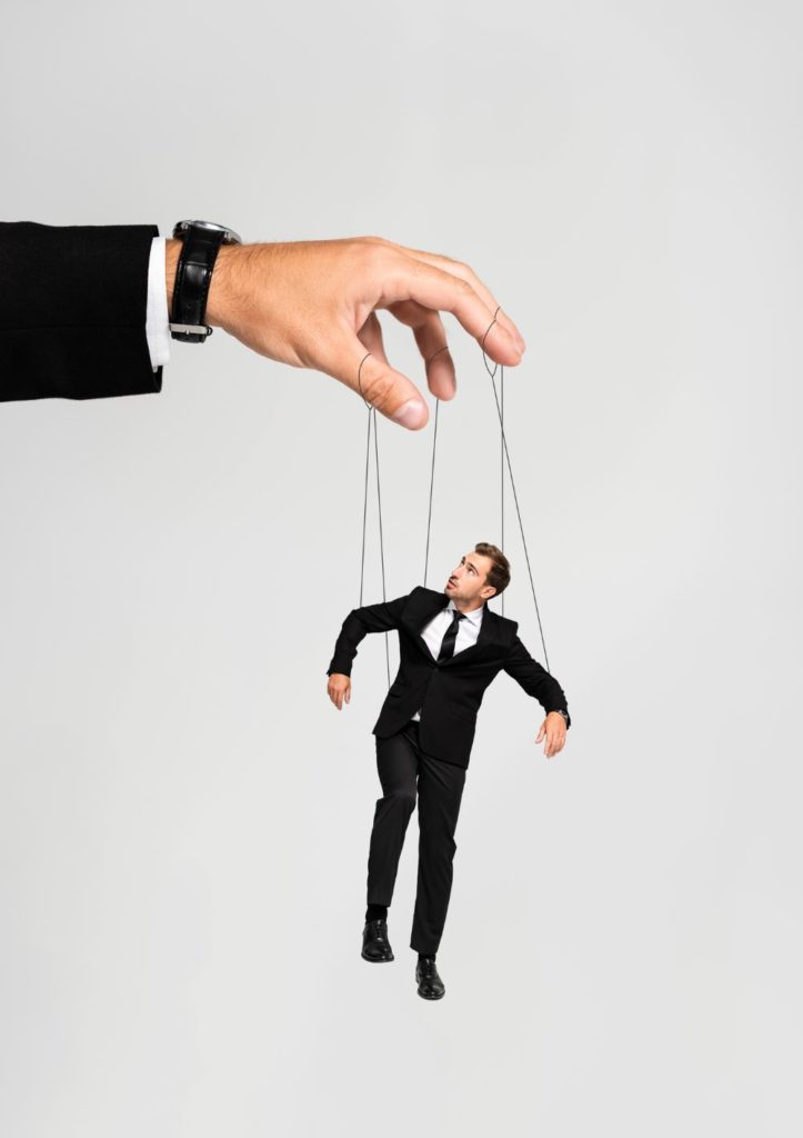 Cropped view of businessman playing with marionette