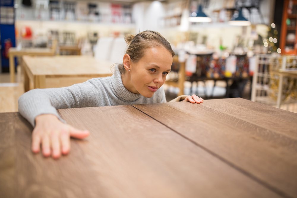 Pretty, young woman choosing the right furniture for her apartment in a modern home furnishings store (color toned image; shallow DOF)
cleaning furniture