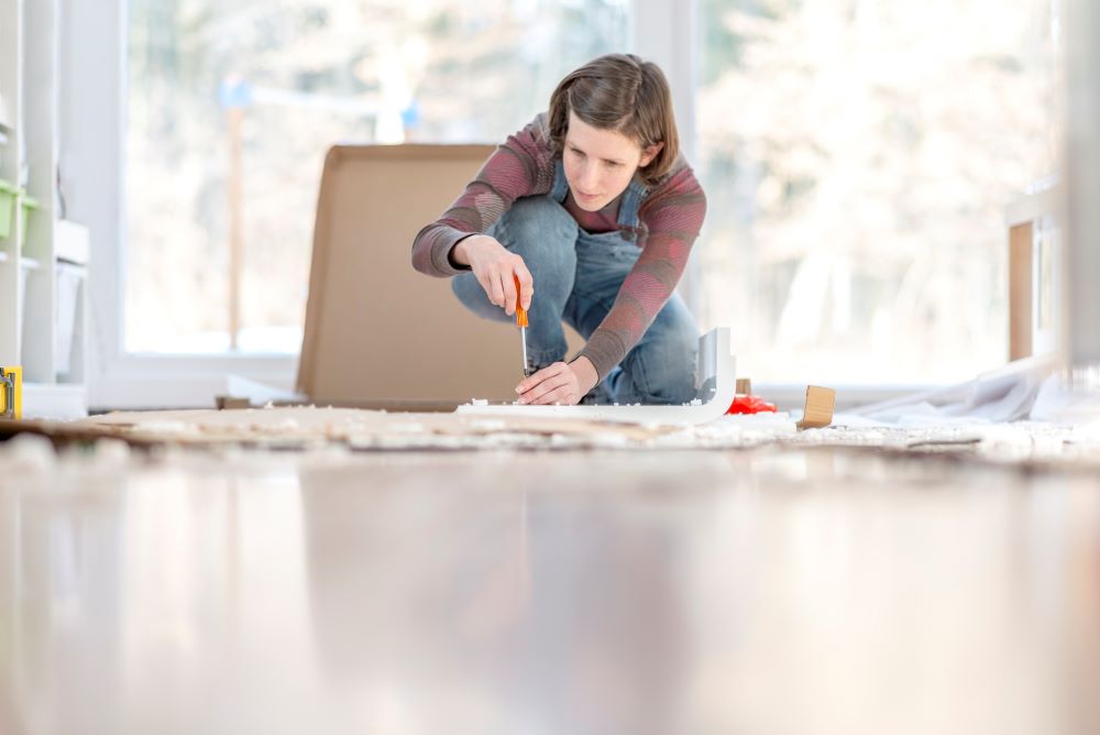 Young Woman assembling a DIY furniture