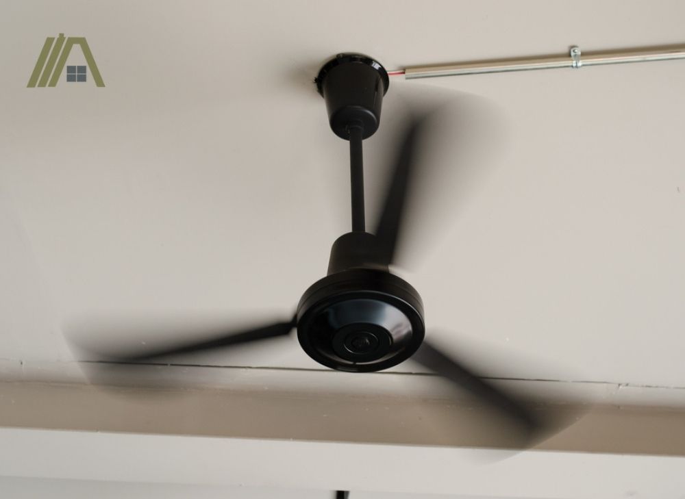 Moving black ceiling fan
