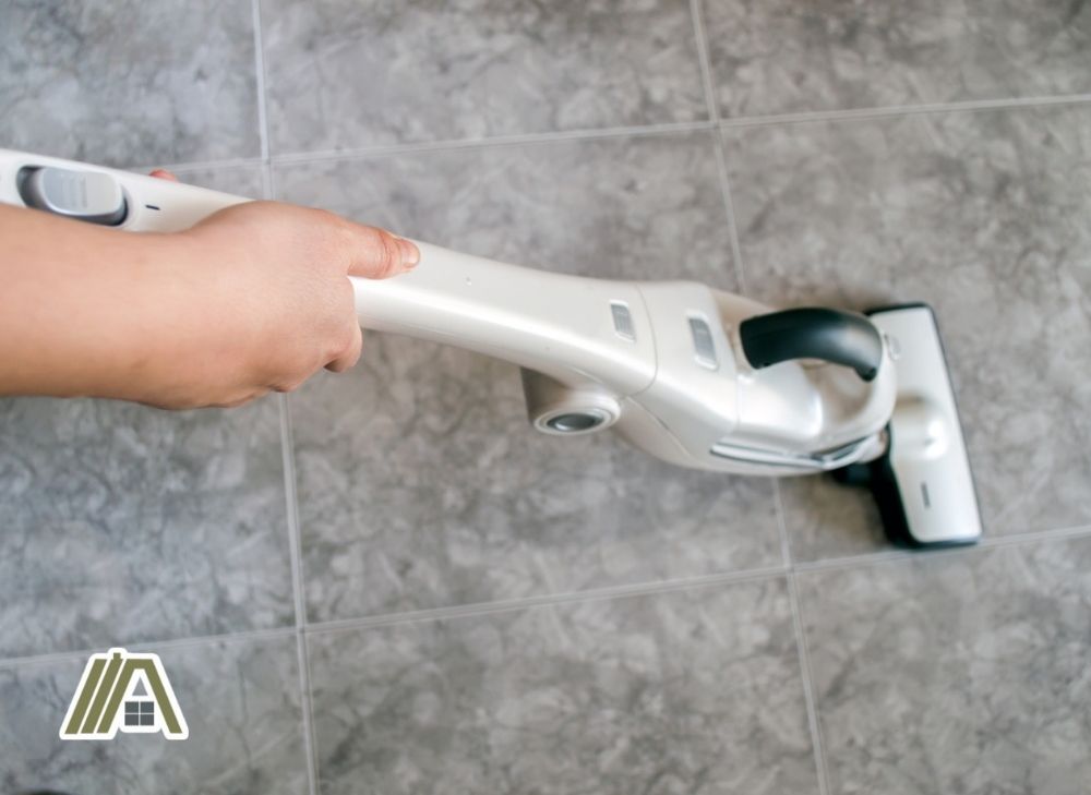 Cleaning the bathroom floor using a vacuum cleaner