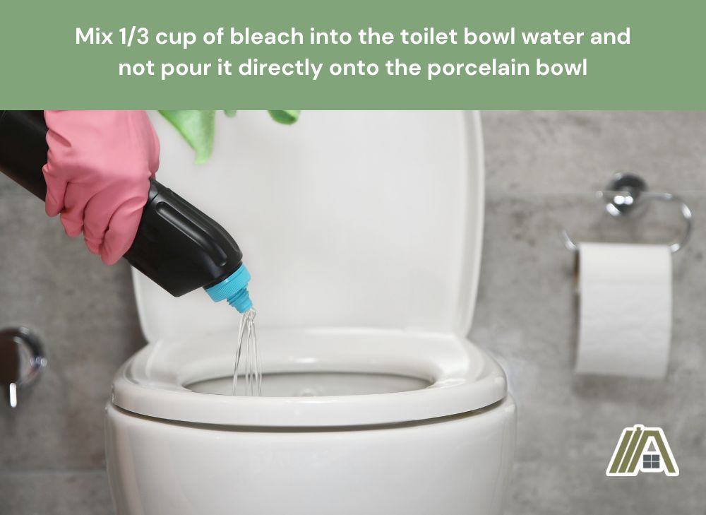 Hand with gloves pouring bleach into the toilet bowl water