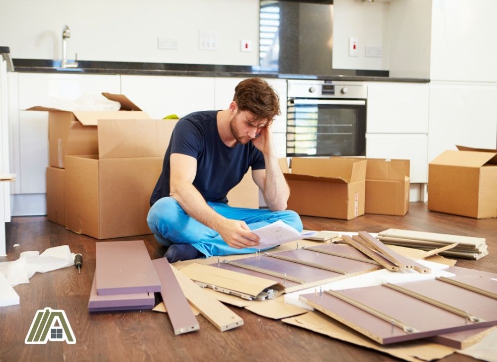 Man frustrated while assembling furniture