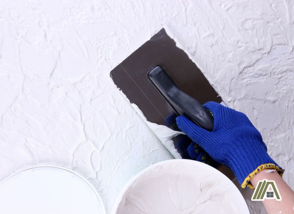 Smoothening the plaster using a plastering trowel