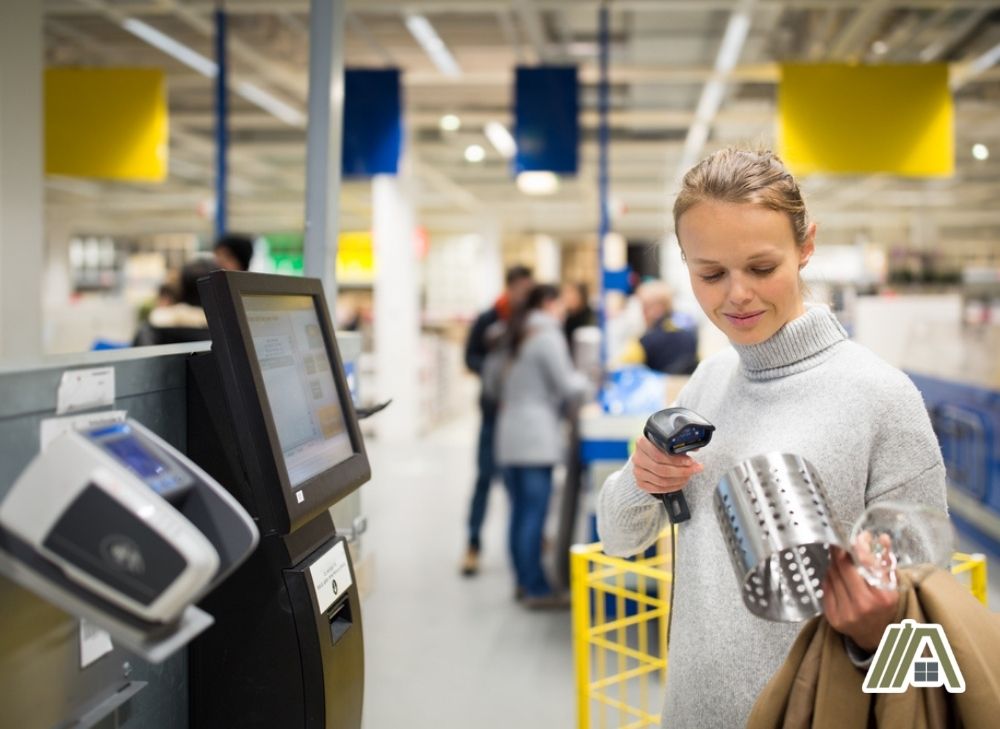 Woman scanning an item on IKEA for checkout