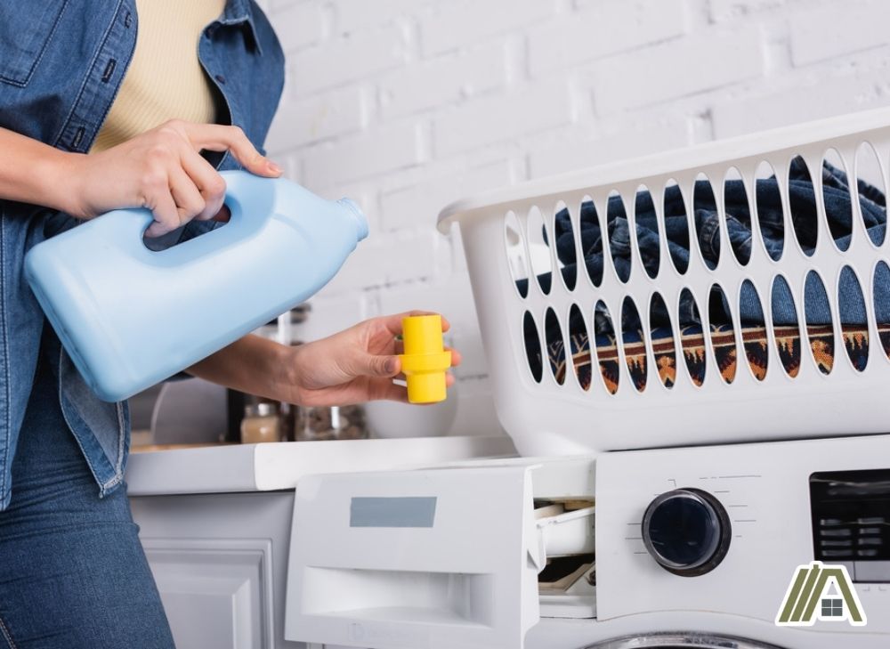 woman pouring detergent in the washing machine