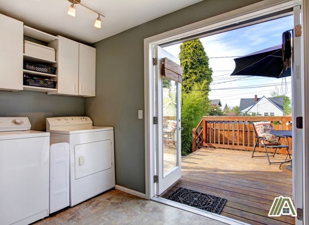 Gas dryer and washer in a laundry room with double doors connected in the backyard.jpg