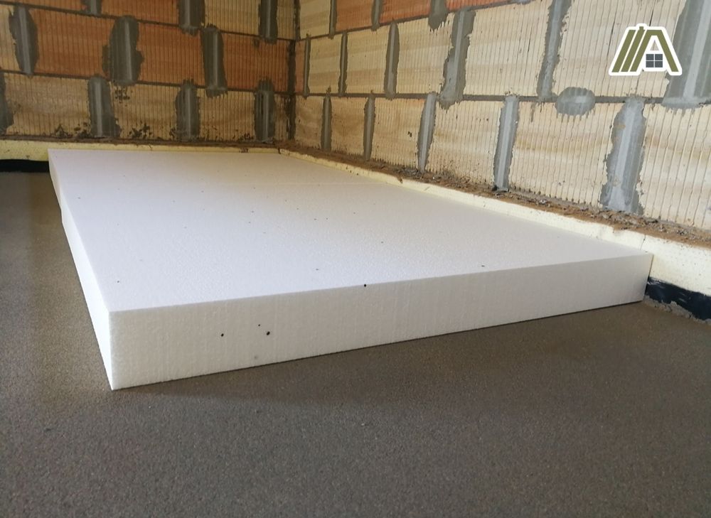 Sheet of expanded polystyrene foam board on the concrete floor.jpg
